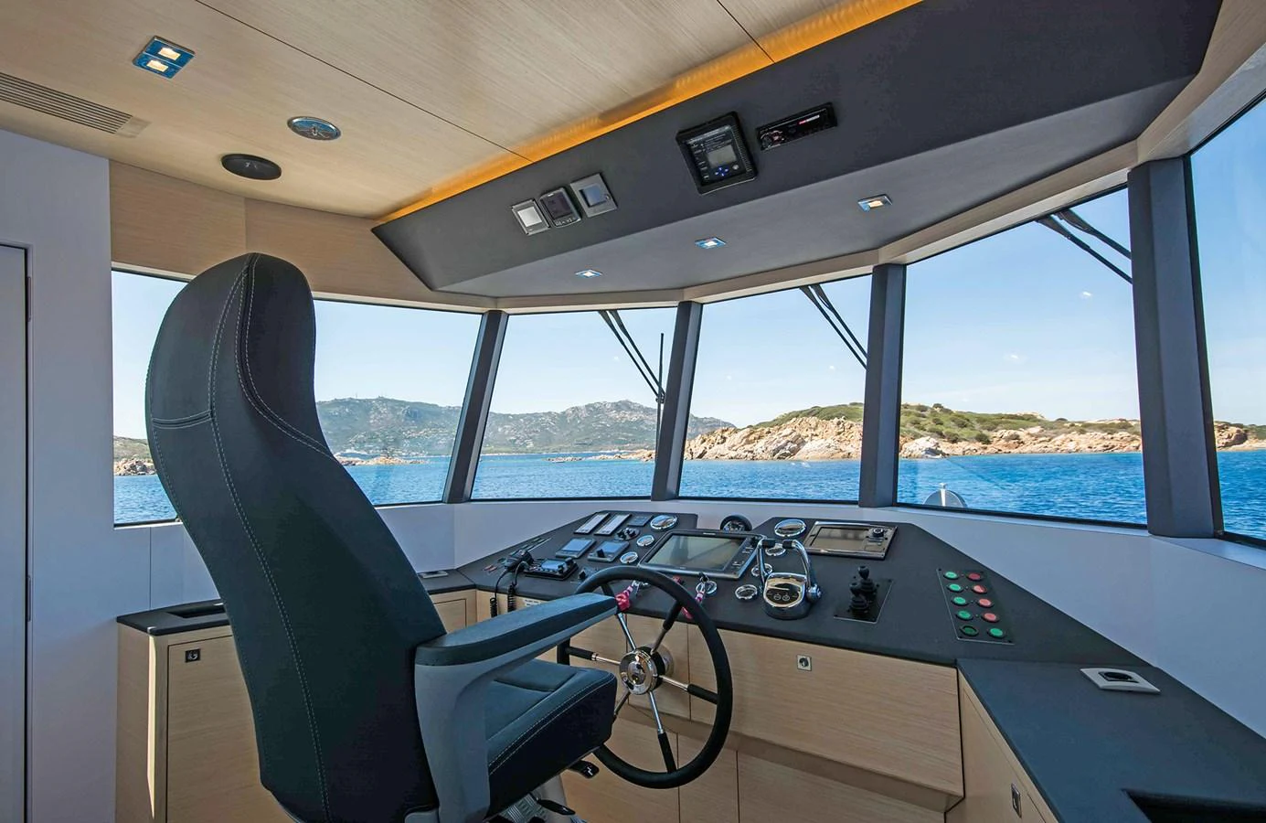 The helm offers a commanding view with modern navigation equipment and a comfortable captain's chair. aboard 20 YXT Yacht for Sale