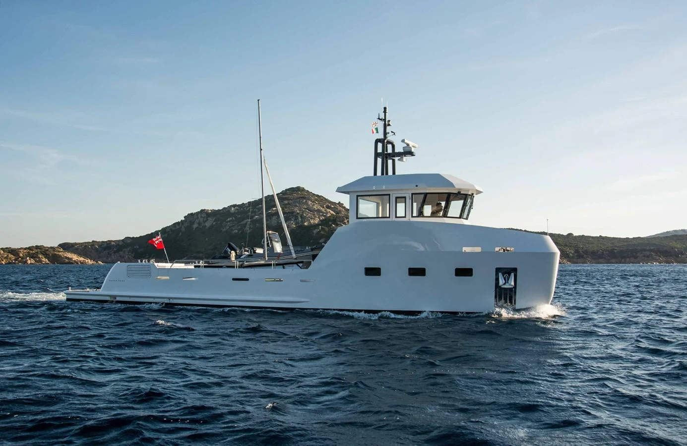 A sleek yacht cruises through the water with a scenic coastline in the background. aboard 20 YXT Yacht for Sale