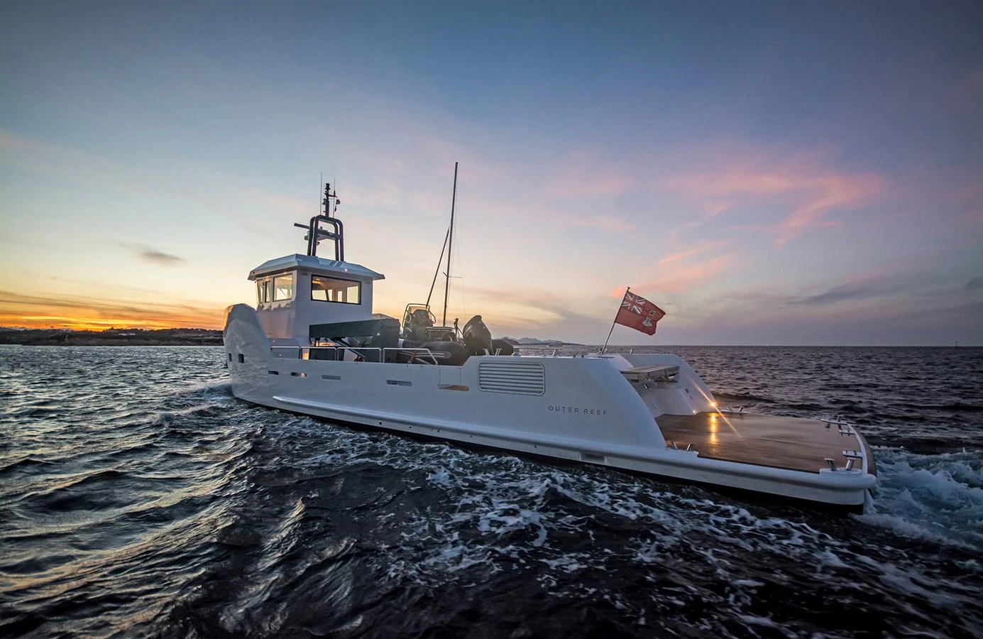 A sleek yacht cruises through the water at sunset, showcasing its modern design and elegant lines. aboard 20 YXT Yacht for Sale