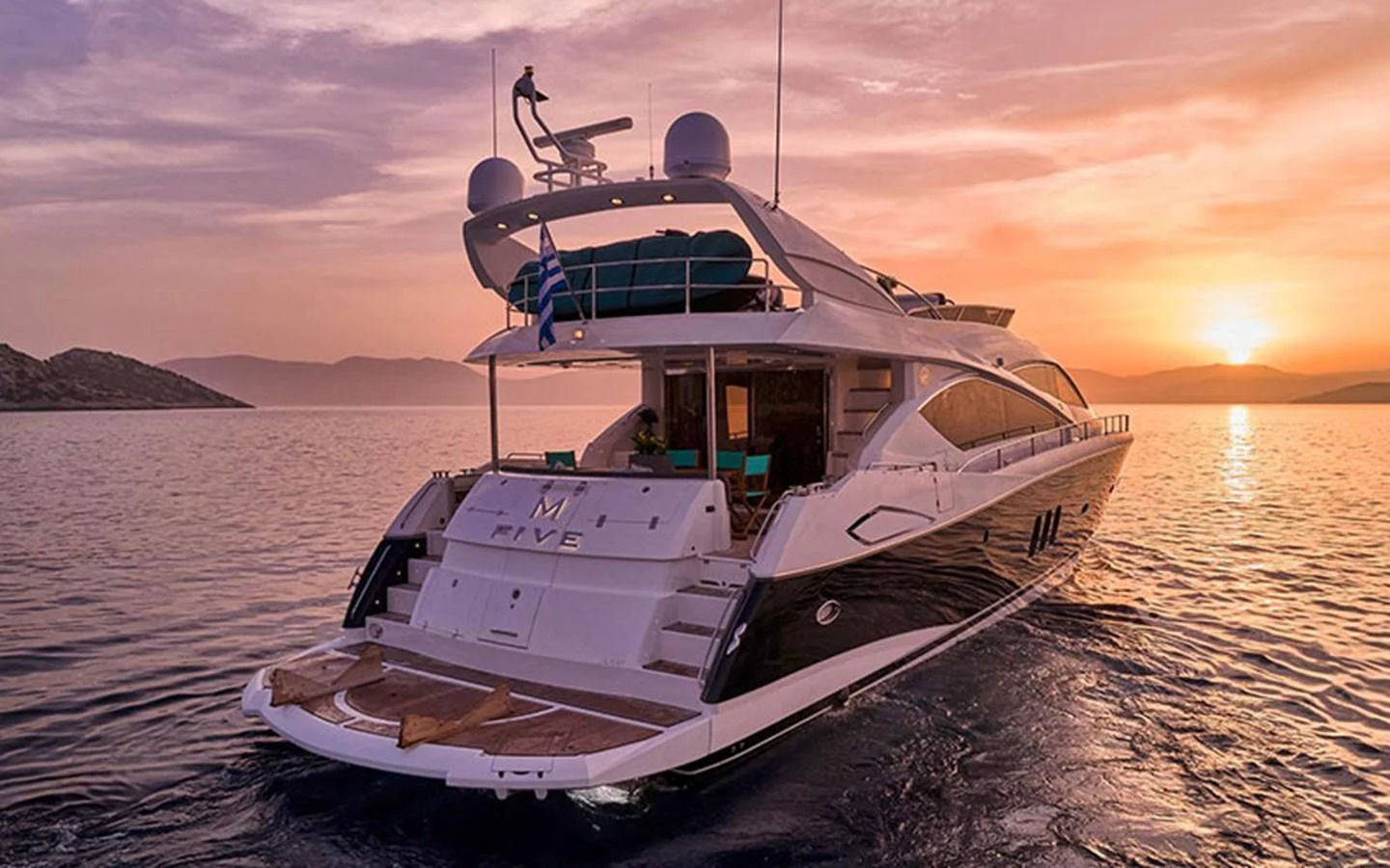 A luxurious yacht is anchored at sunset, showcasing its sleek design and inviting aft deck. aboard M FIVE Yacht for Sale