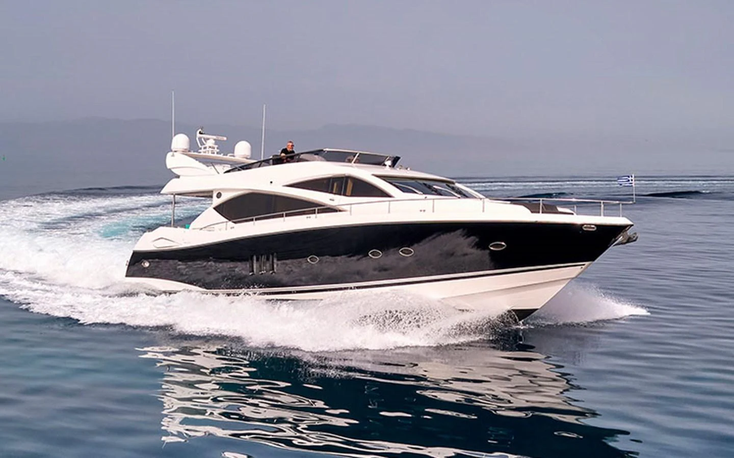A sleek and modern yacht cruises swiftly on calm waters, showcasing its elegant design. aboard M FIVE Yacht for Sale