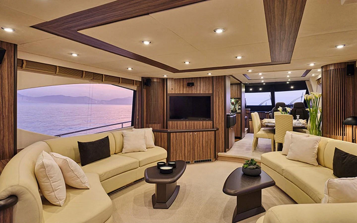 The salon features luxurious seating with a stunning view of the ocean through large windows. aboard M FIVE Yacht for Sale