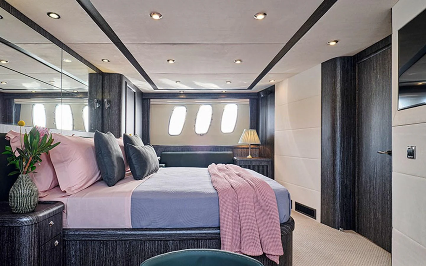 The master stateroom features a luxurious bed with elegant decor and ample natural light from the windows. aboard M FIVE Yacht for Sale