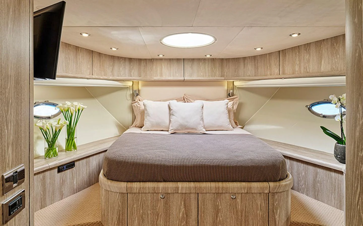 The master stateroom features a luxurious bed with elegant lighting and decor. aboard M FIVE Yacht for Sale