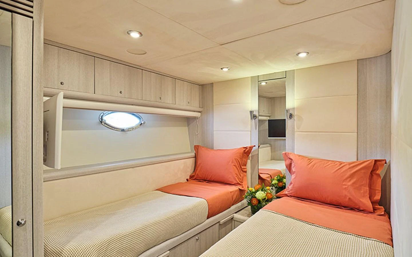 The twin stateroom features two single beds with vibrant orange bedding and a modern, well-lit design. aboard M FIVE Yacht for Sale
