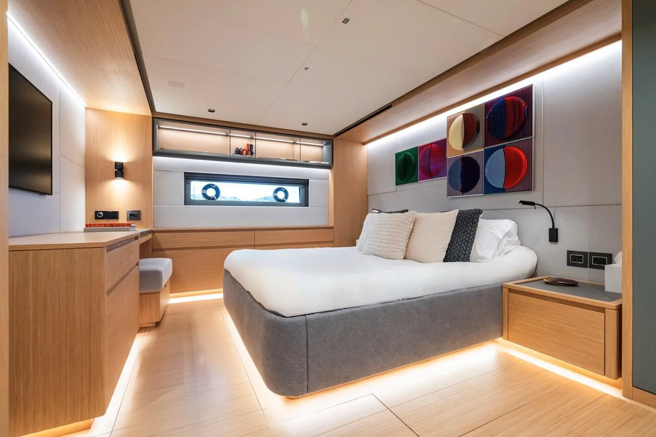 The master stateroom features a modern design with a spacious bed and ambient lighting. aboard SIMON Yacht for Sale