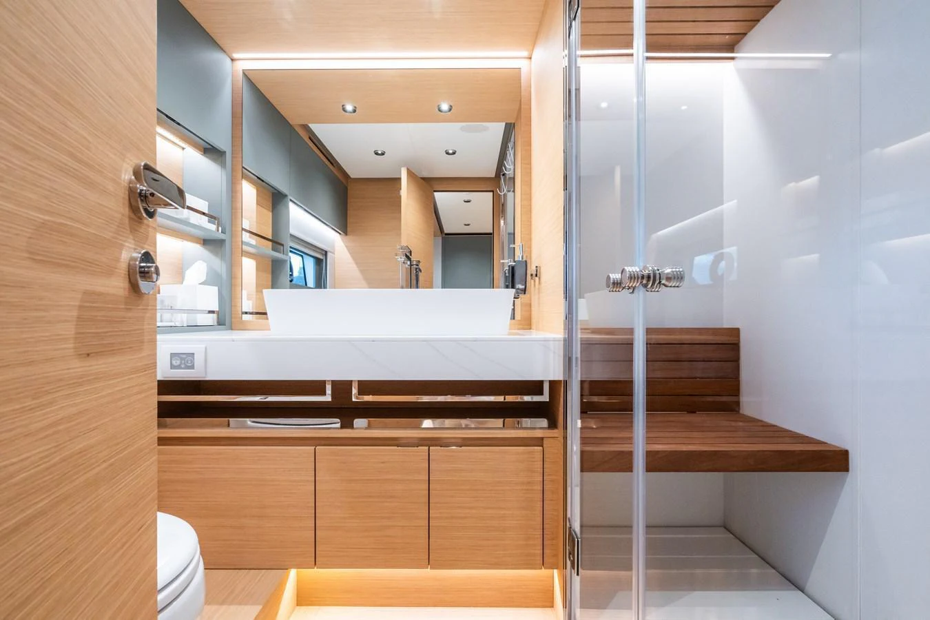 The yacht's bathroom features modern fixtures and elegant wood paneling. aboard SIMON Yacht for Sale