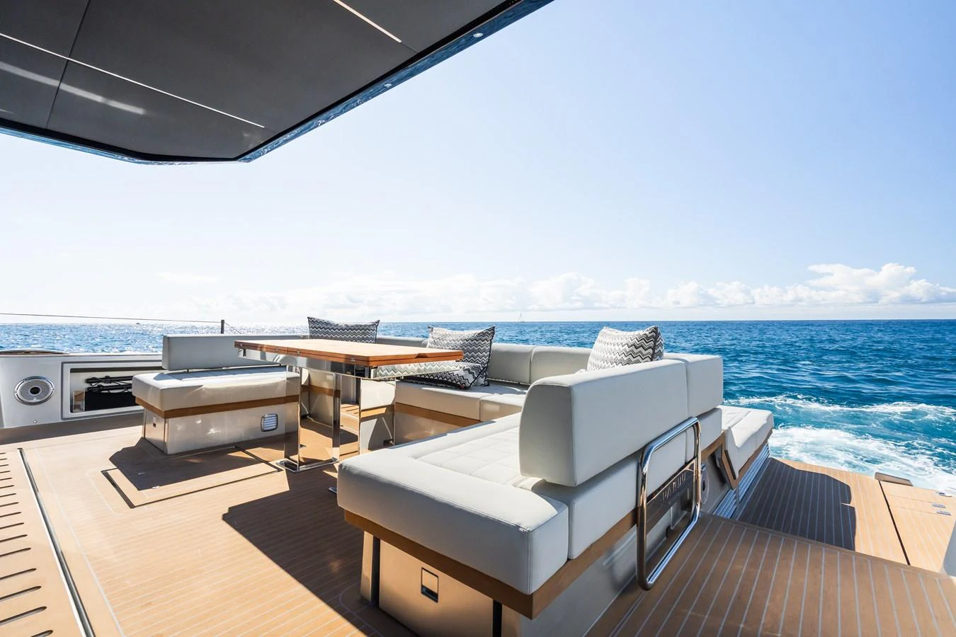 The aft deck offers a luxurious outdoor seating area with stunning ocean views. aboard SIMON Yacht for Sale