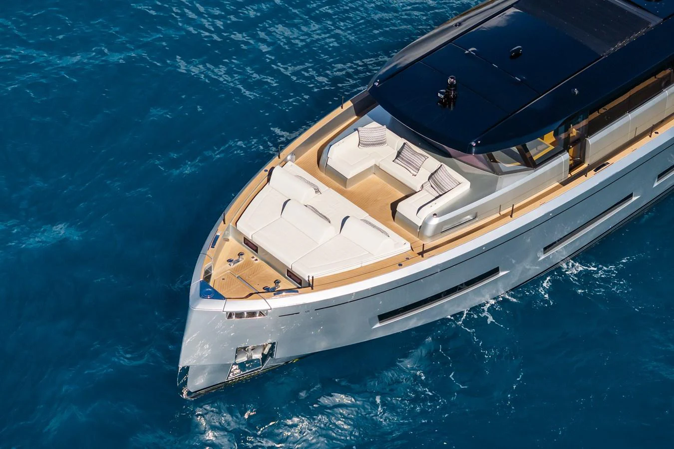 The yacht's sleek foredeck features luxurious sun pads and elegant design, perfect for relaxation. aboard SIMON Yacht for Sale