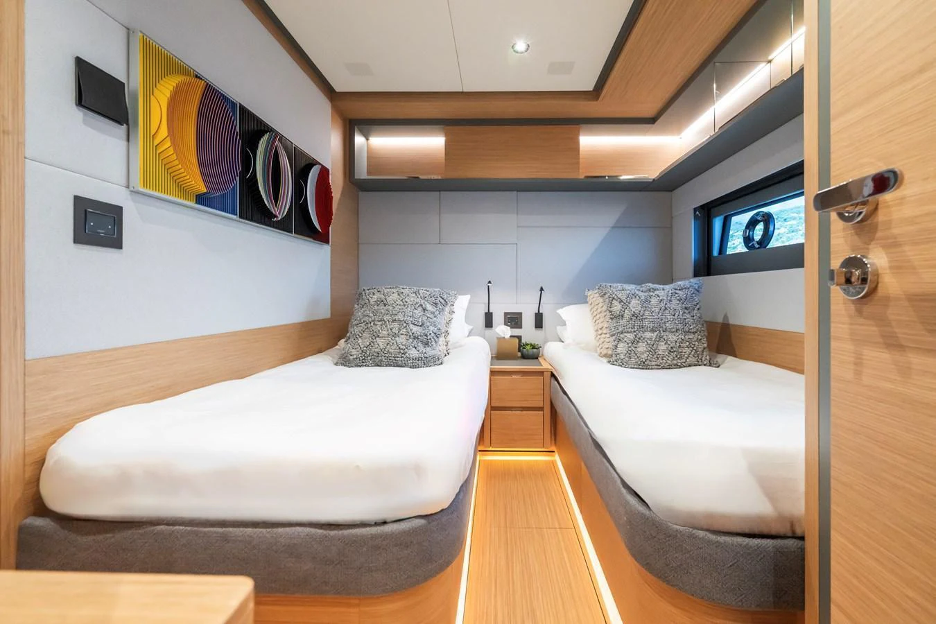 The guest stateroom features twin beds and modern decor, offering a cozy and stylish retreat. aboard SIMON Yacht for Sale