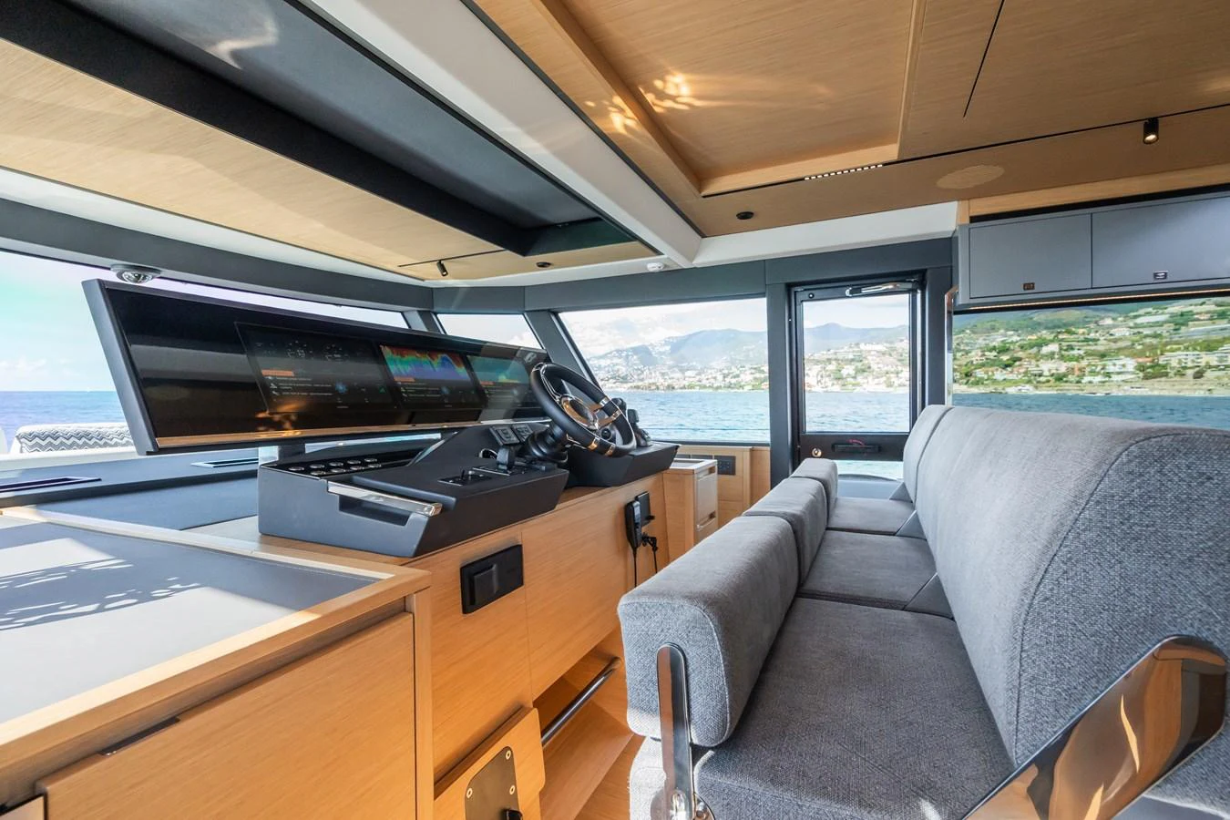 The helm station features modern controls and a comfortable seating area with panoramic views. aboard SIMON Yacht for Sale