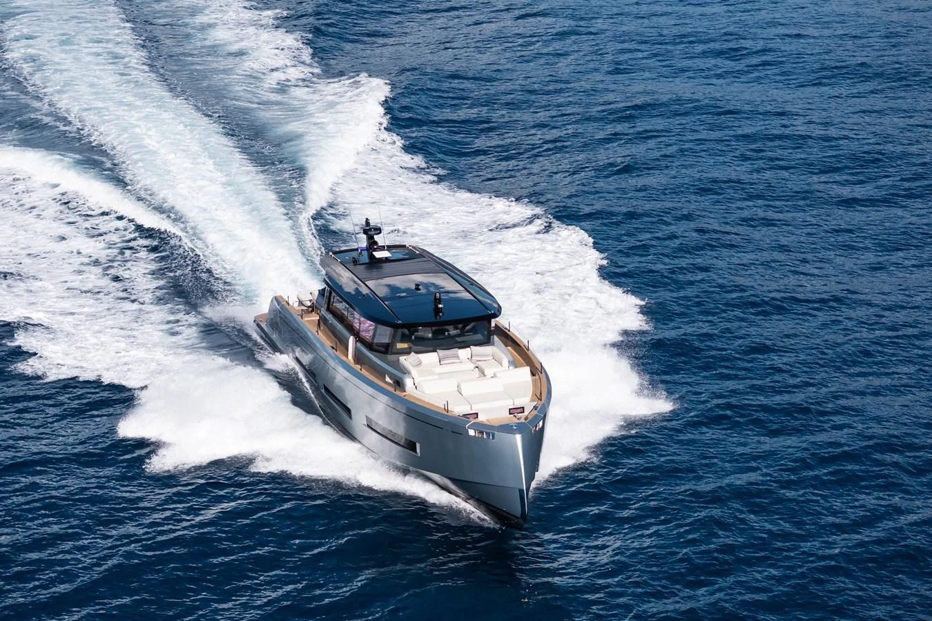 A sleek yacht cruises swiftly through the open sea, leaving a trail of white wake behind. aboard SIMON Yacht for Sale