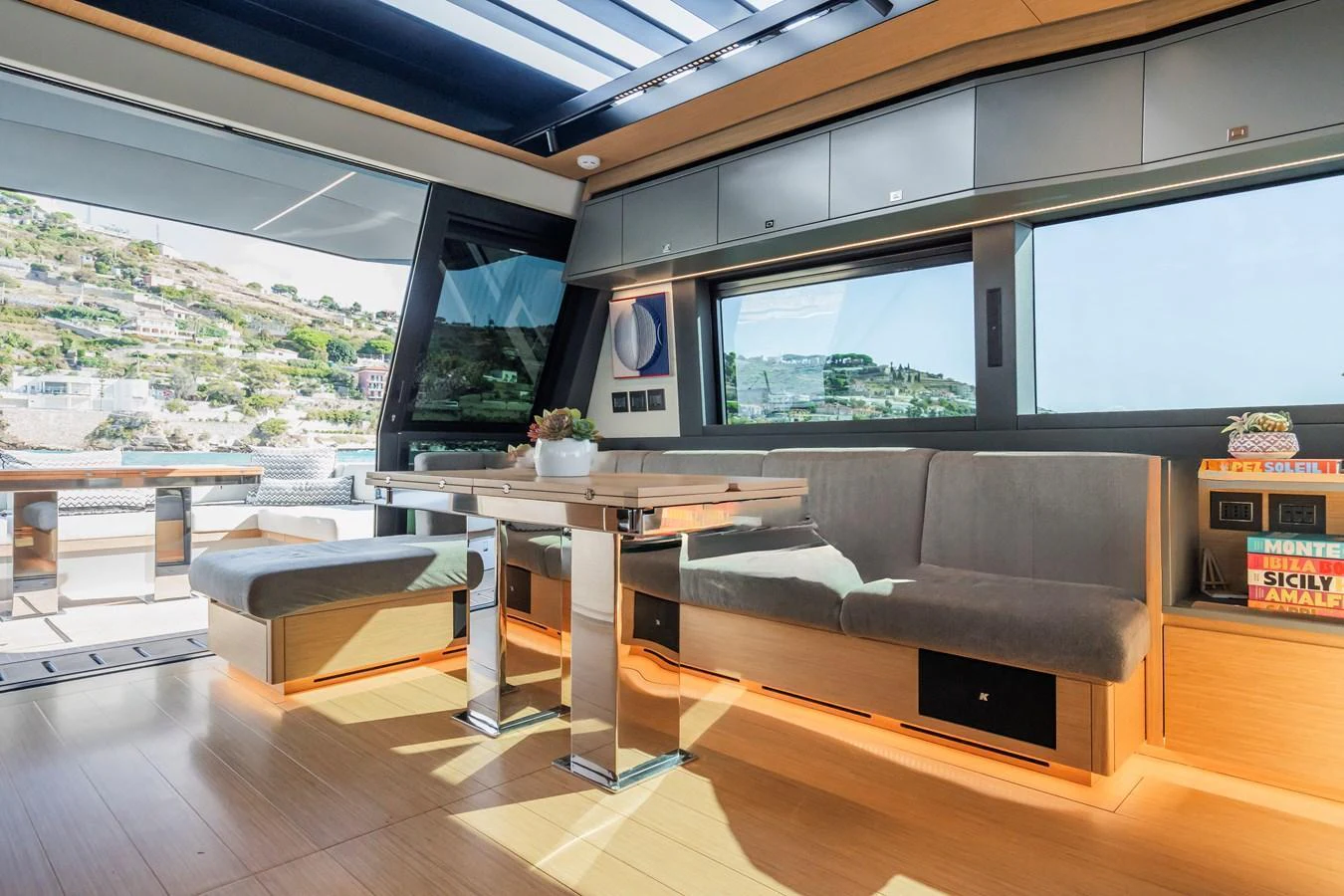 The salon features modern furnishings with ample natural light and scenic views. aboard SIMON Yacht for Sale