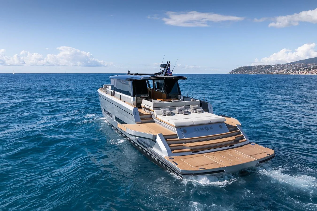 A sleek yacht cruising on open waters with a spacious aft deck for relaxation. aboard SIMON Yacht for Sale