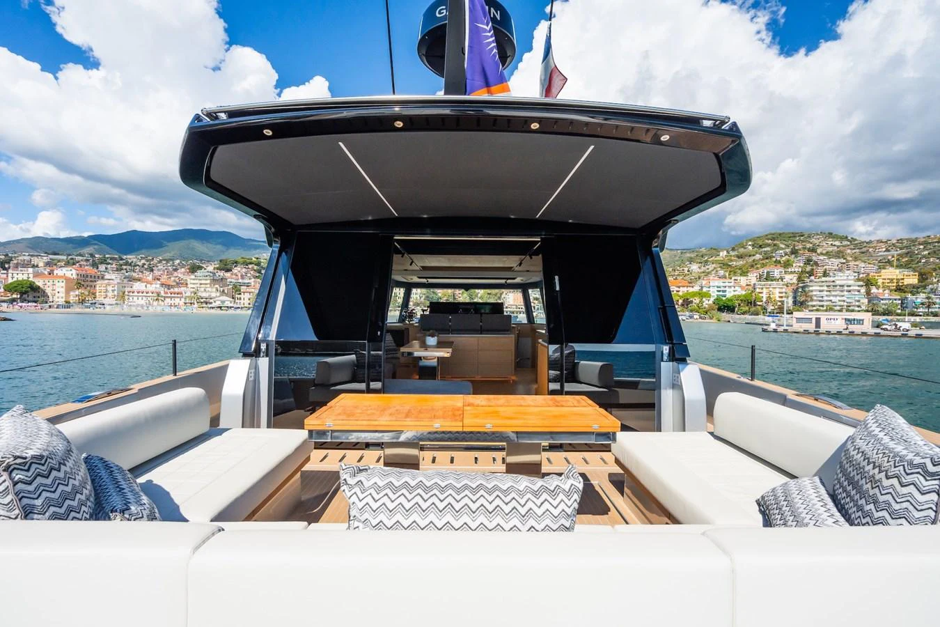 The aft deck offers a spacious and stylish outdoor seating area with a beautiful view of the surrounding coastline. aboard SIMON Yacht for Sale