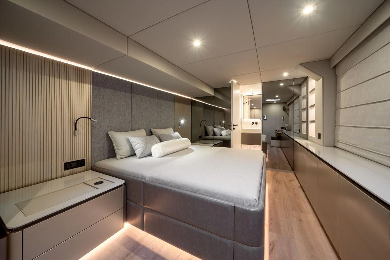 The master stateroom features a luxurious bed with modern lighting and sleek design elements. aboard THOR Yacht for Sale
