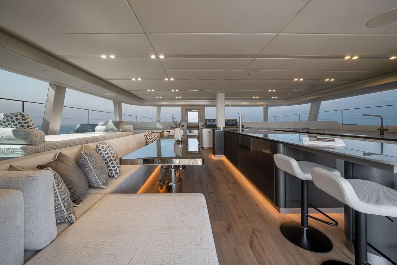The spacious salon features modern furnishings and ample natural light, creating a luxurious and inviting atmosphere. aboard THOR Yacht for Sale