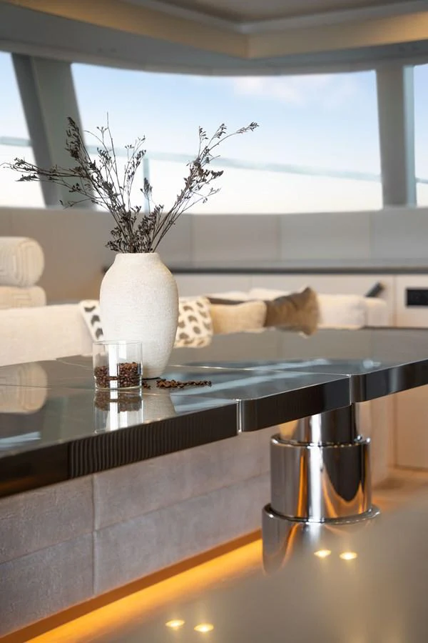 A stylish interior setting with a modern table and elegant decor. aboard THOR Yacht for Sale