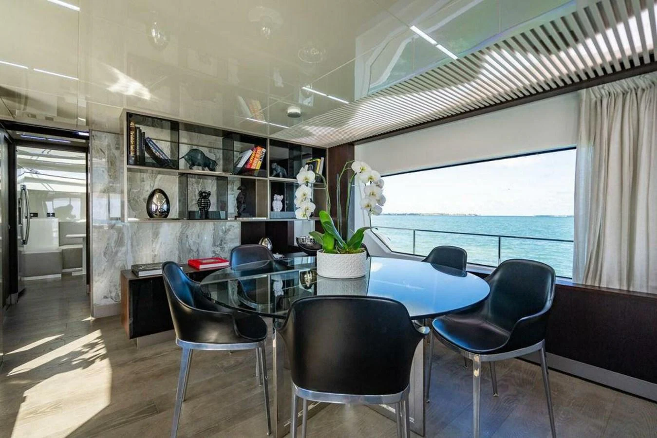 a room with a table chairs and a window aboard 85 FERRETTI Yacht for Sale