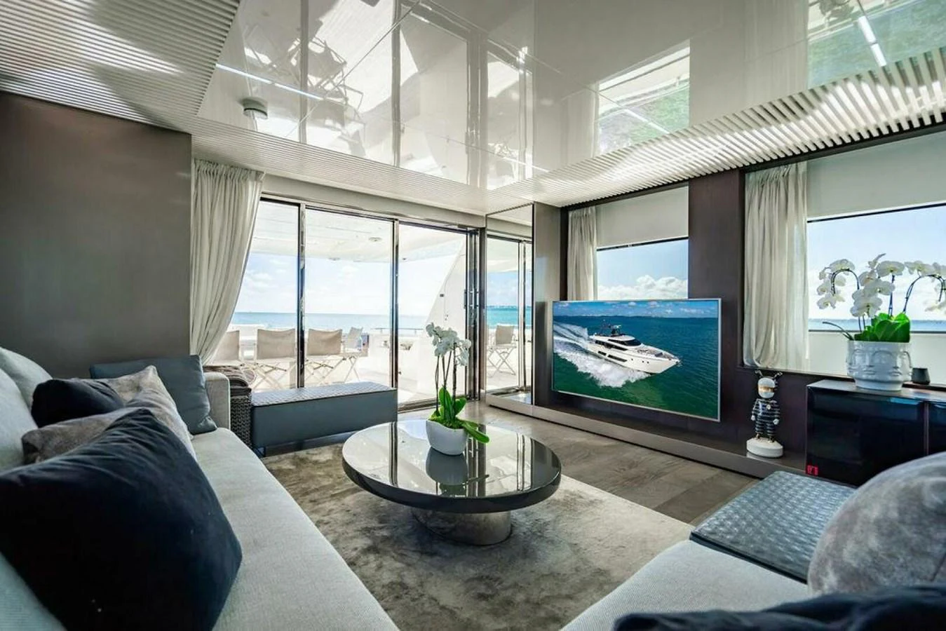 a living room with a large window aboard 85 FERRETTI Yacht for Sale
