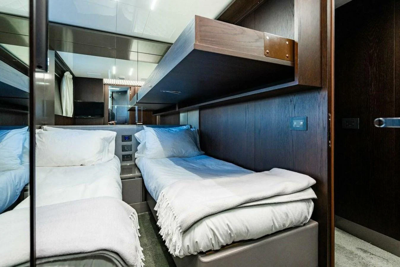 a room with beds and a wood door aboard 85 FERRETTI Yacht for Sale