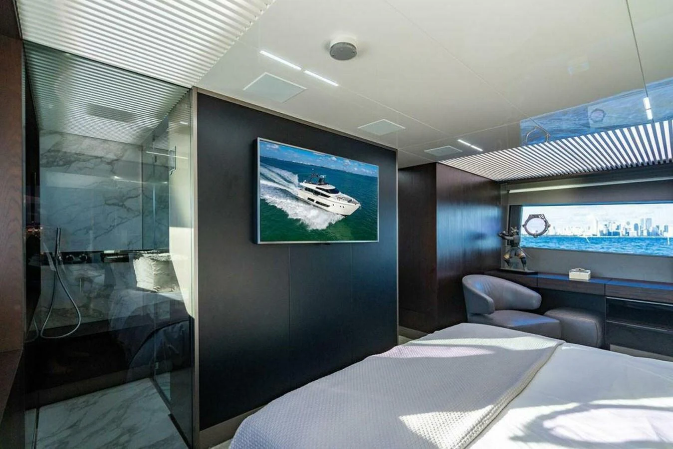 a room with a tv and a bed aboard 85 FERRETTI Yacht for Sale