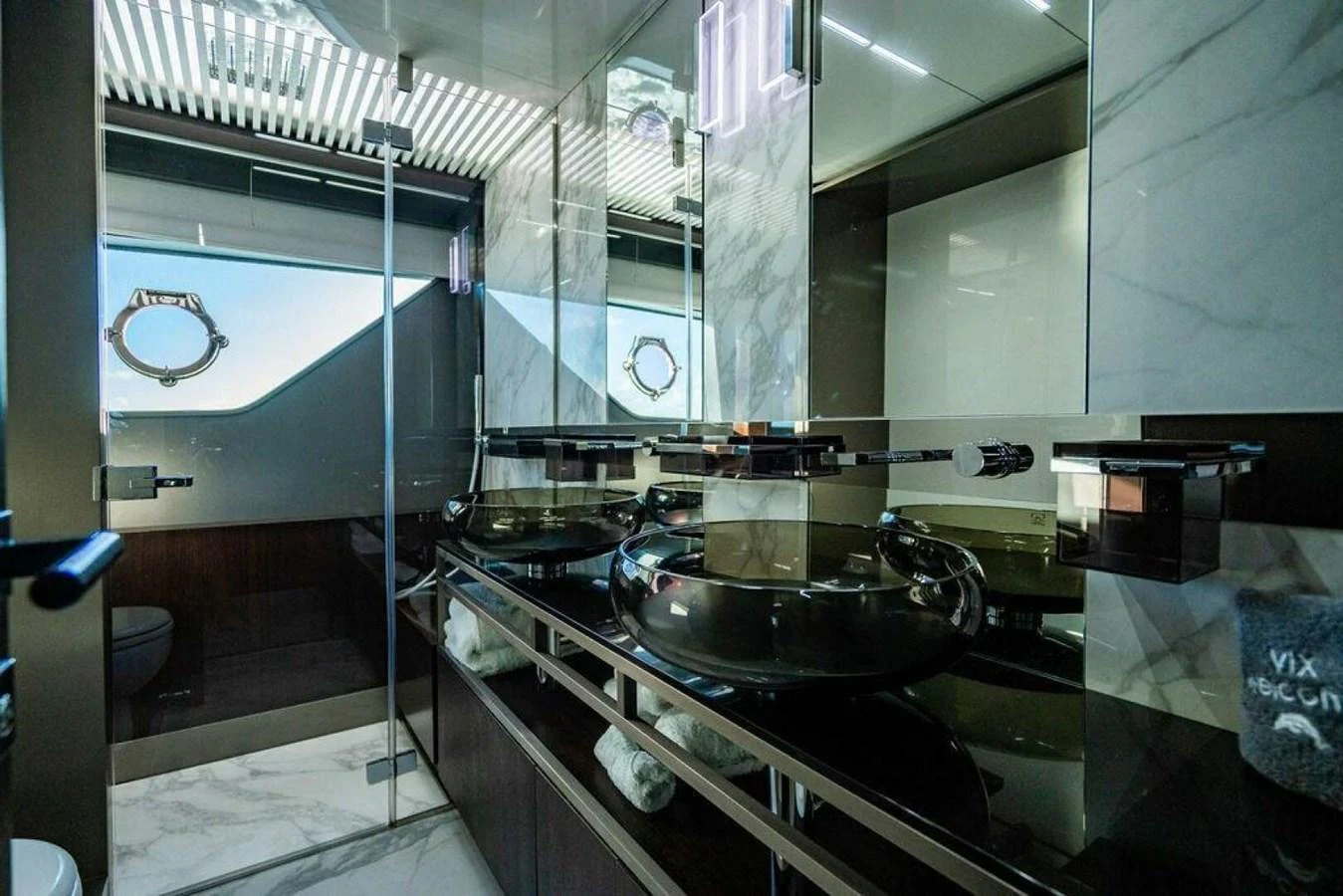 a bathroom with a sink and a mirror aboard 85 FERRETTI Yacht for Sale