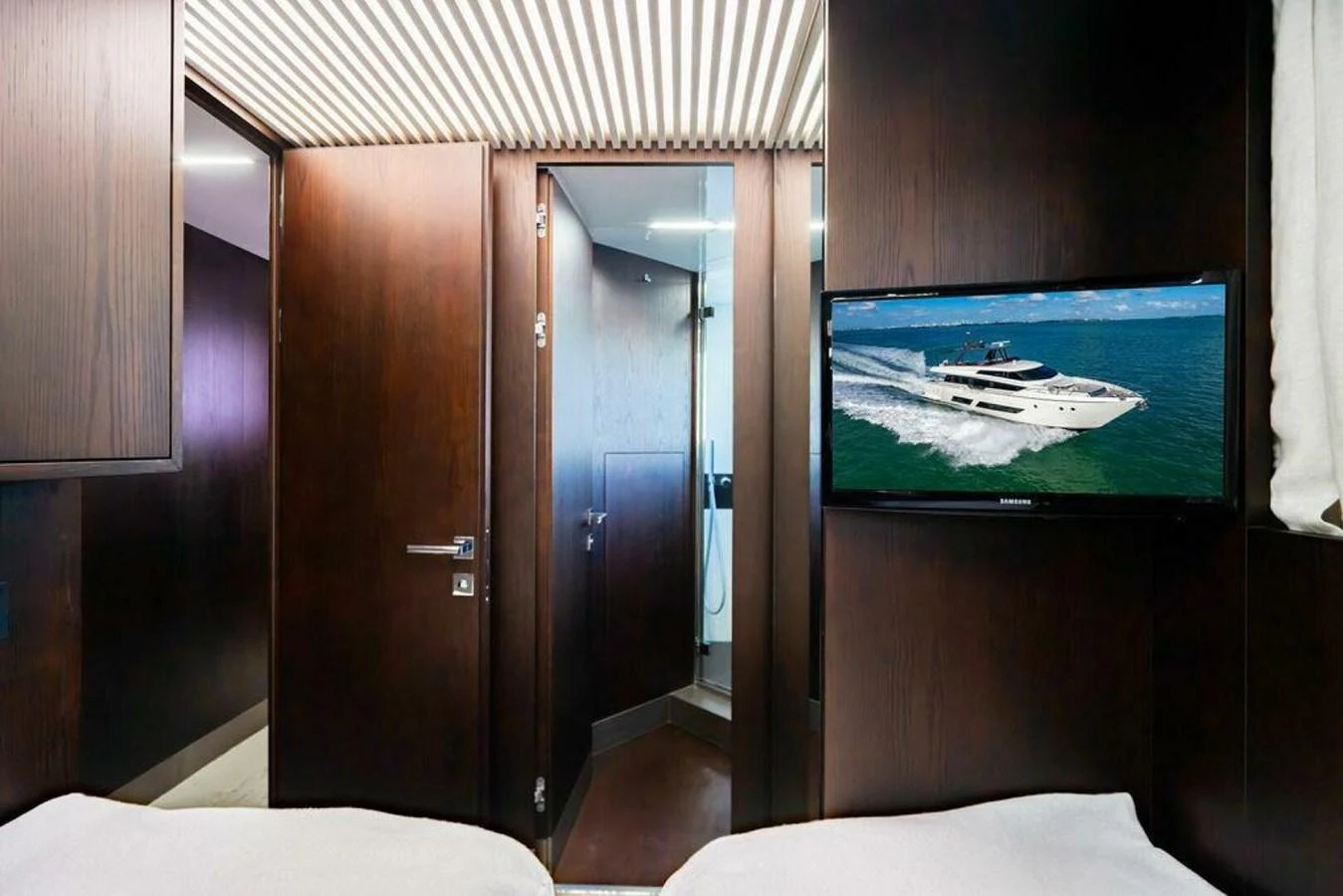 a room with a television and a bed aboard 85 FERRETTI Yacht for Sale