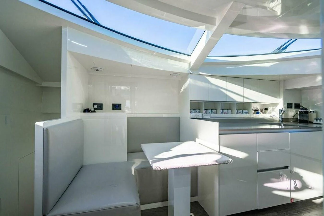 a room with a table and chairs aboard 85 FERRETTI Yacht for Sale
