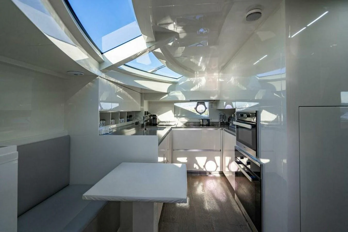 a room with a table and a window aboard 85 FERRETTI Yacht for Sale
