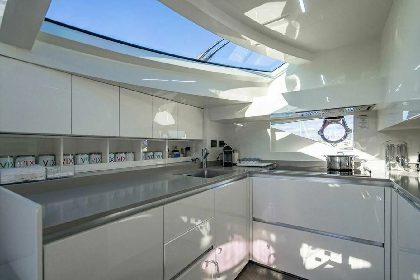 a kitchen with white cabinets aboard 85 FERRETTI Yacht for Sale
