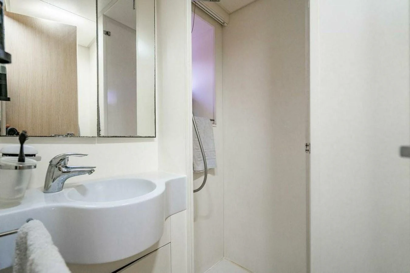 a bathroom with a sink and a mirror aboard 85 FERRETTI Yacht for Sale