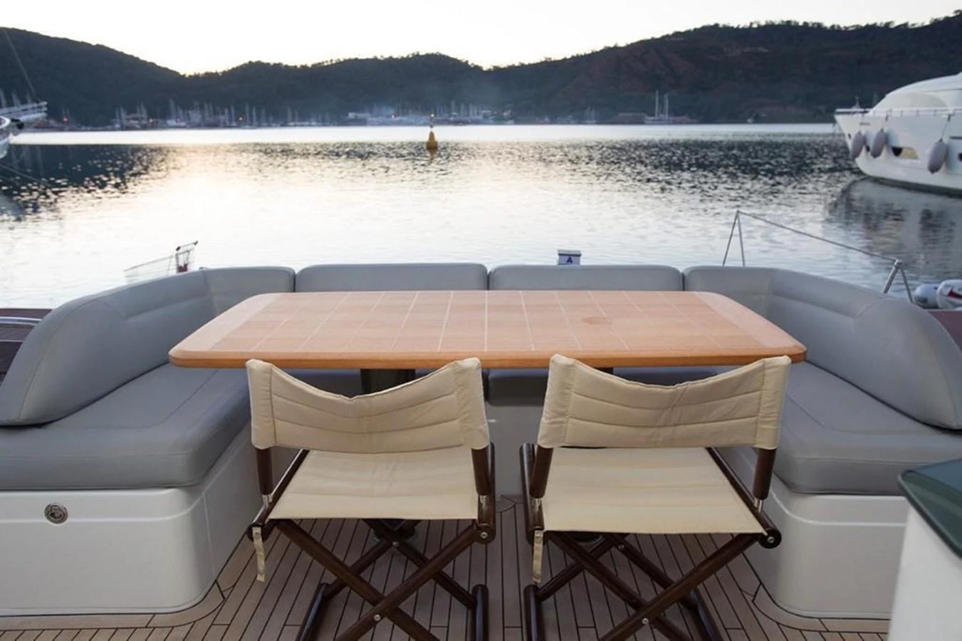 The aft deck features a cozy dining area with a beautiful view of the water. aboard RAINBOW Yacht for Sale
