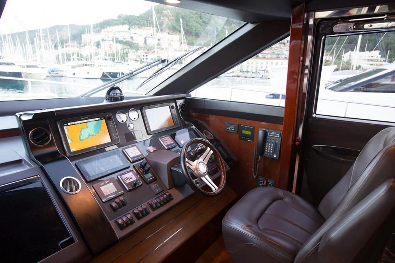 The helm station features advanced navigation equipment and a comfortable captain's chair, offering a commanding view of the surroundings. aboard RAINBOW Yacht for Sale