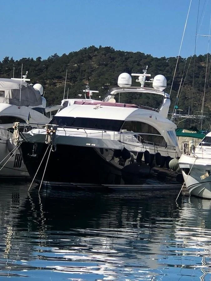 A sleek yacht is docked in a marina, showcasing its modern design and luxurious features. aboard RAINBOW Yacht for Sale