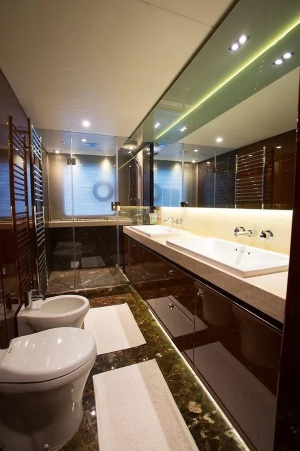 The yacht's bathroom features a sleek design with modern fixtures and luxurious finishes. aboard RAINBOW Yacht for Sale