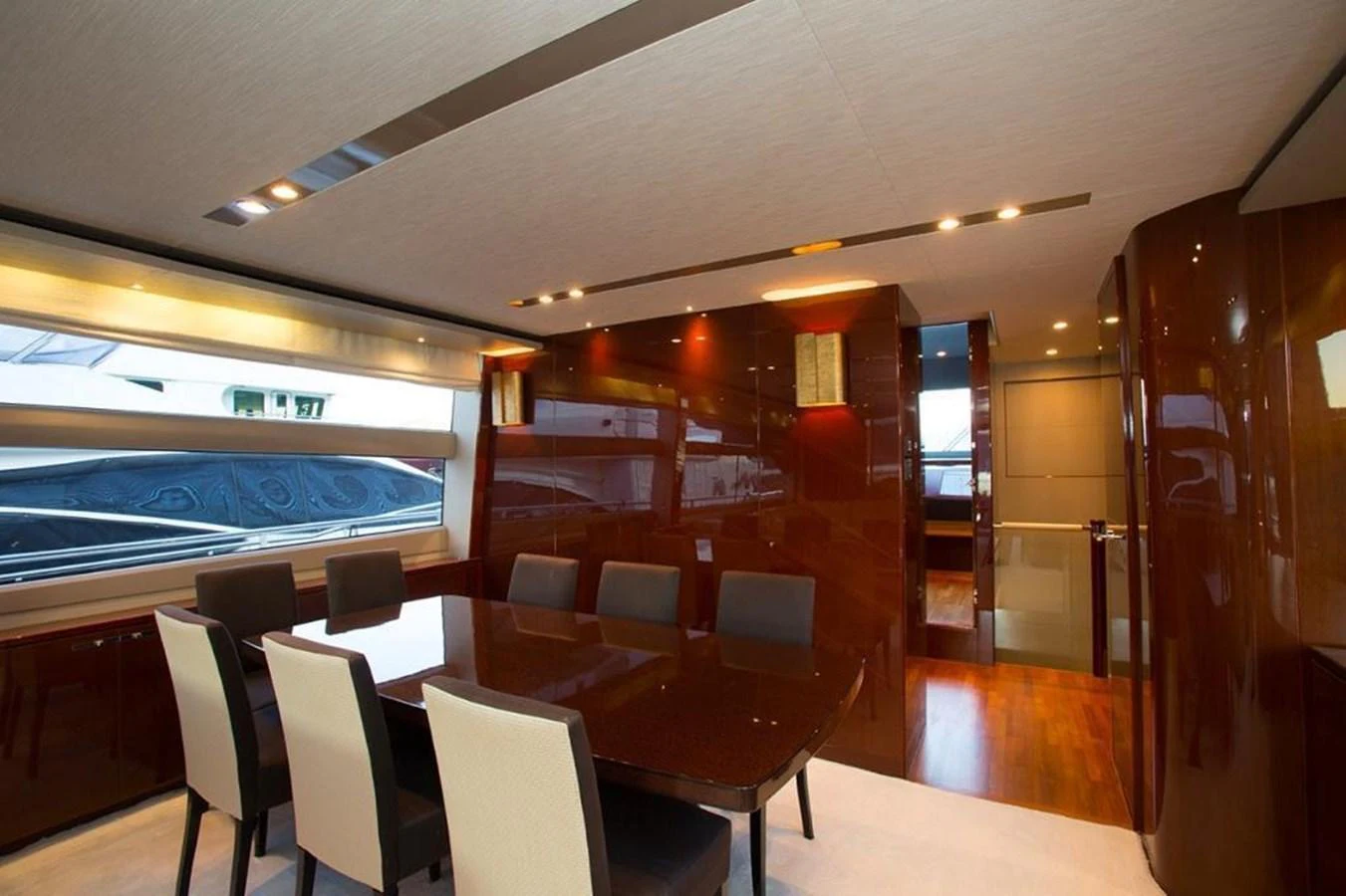 The yacht's dining area features a sleek, modern design with a polished wooden table and comfortable seating. aboard RAINBOW Yacht for Sale