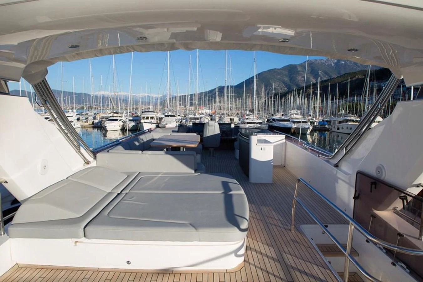 The flybridge offers a spacious lounging area with comfortable seating and stunning marina views. aboard RAINBOW Yacht for Sale