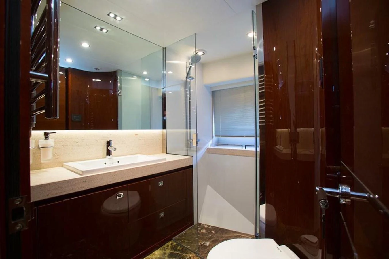 A luxurious yacht bathroom with modern fixtures and elegant finishes. aboard RAINBOW Yacht for Sale