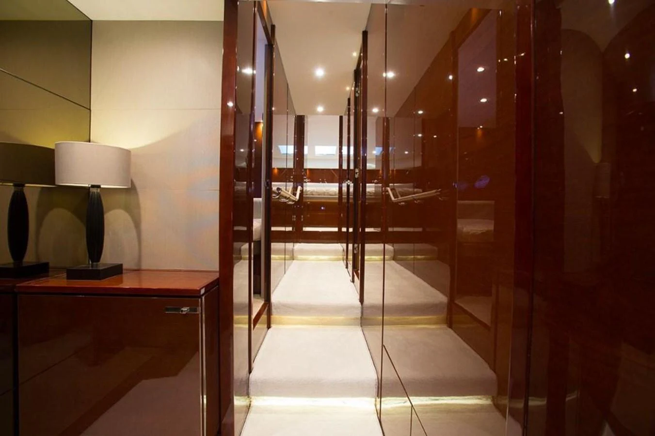 A sleek and polished hallway with glossy wooden panels and modern lighting. aboard RAINBOW Yacht for Sale