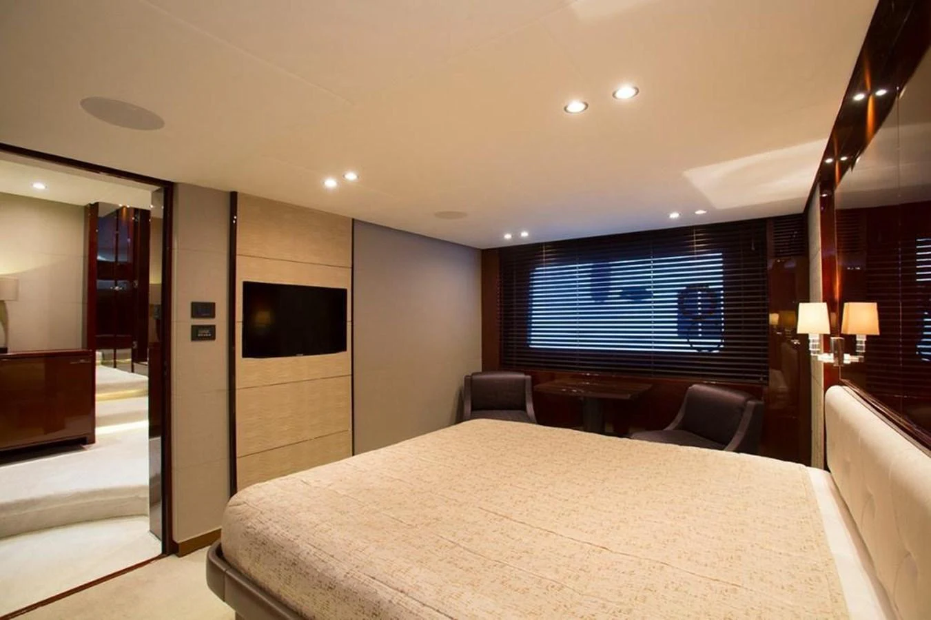 The stateroom features a luxurious bed, ambient lighting, and elegant furnishings. aboard RAINBOW Yacht for Sale