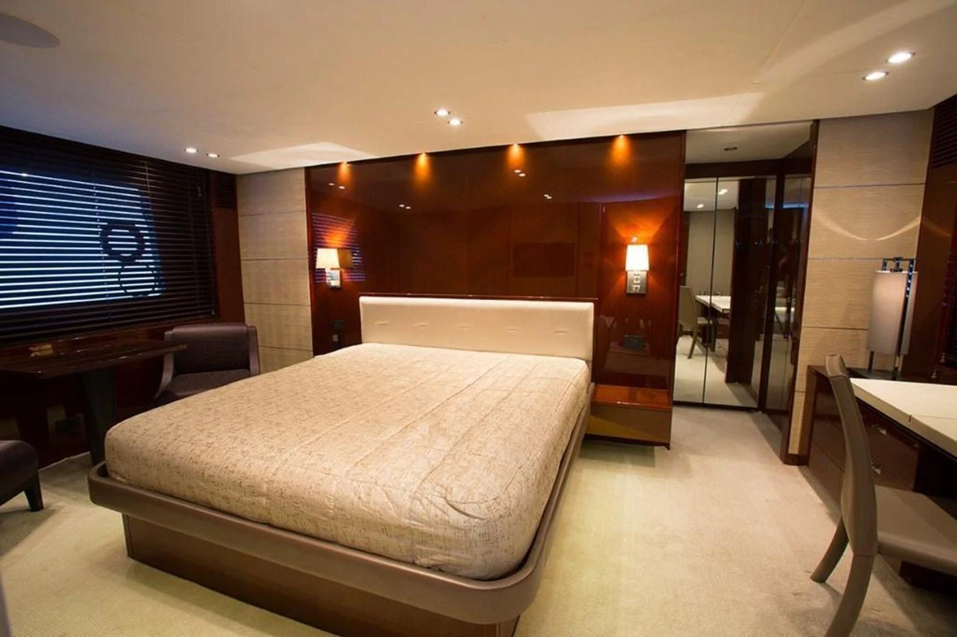 The master stateroom features a spacious bed with elegant lighting and modern decor. aboard RAINBOW Yacht for Sale