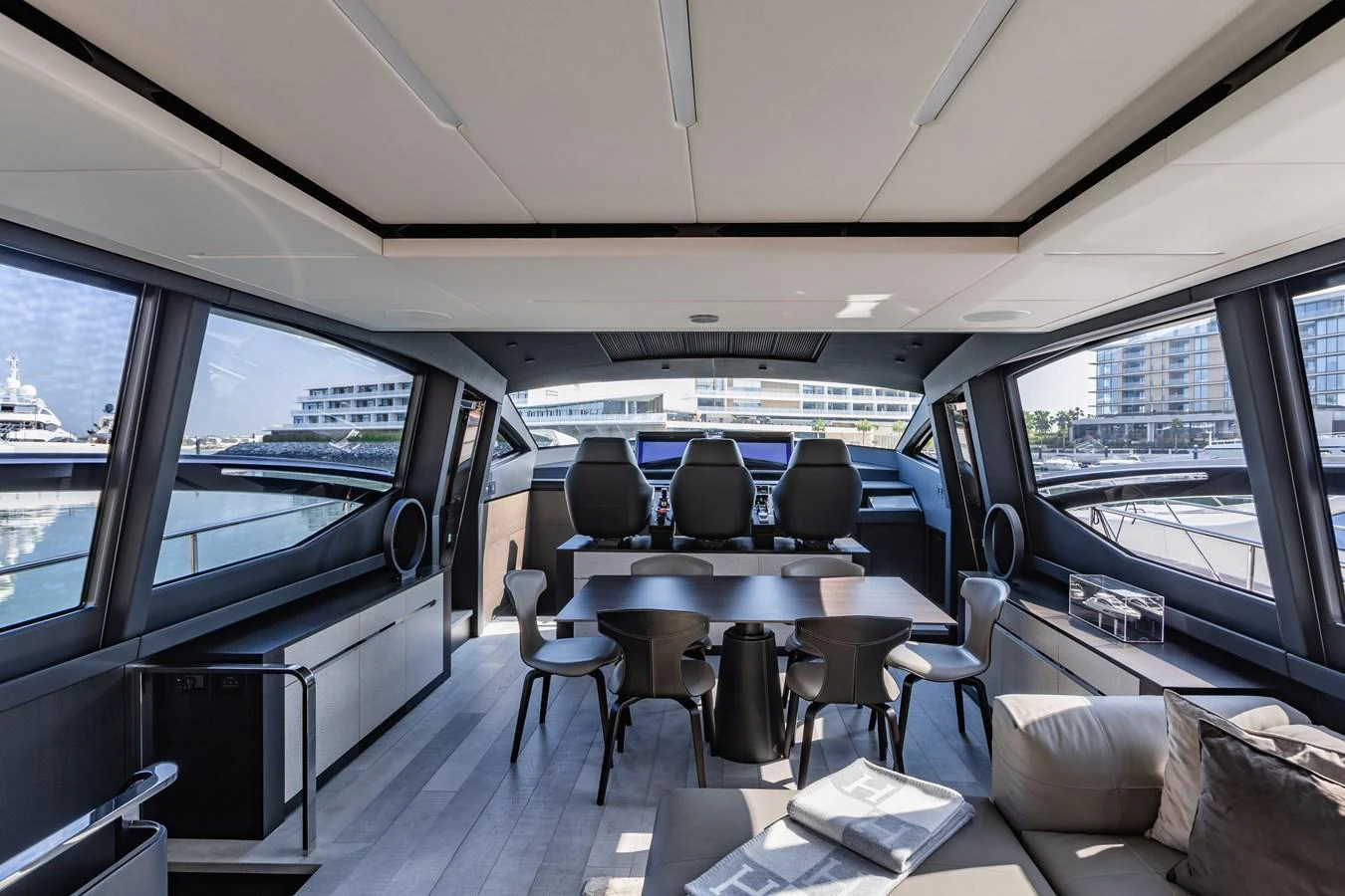 The yacht's salon features a modern and spacious design with ample seating and large windows offering panoramic views. aboard 2021 PERSHING 8X Yacht for Sale