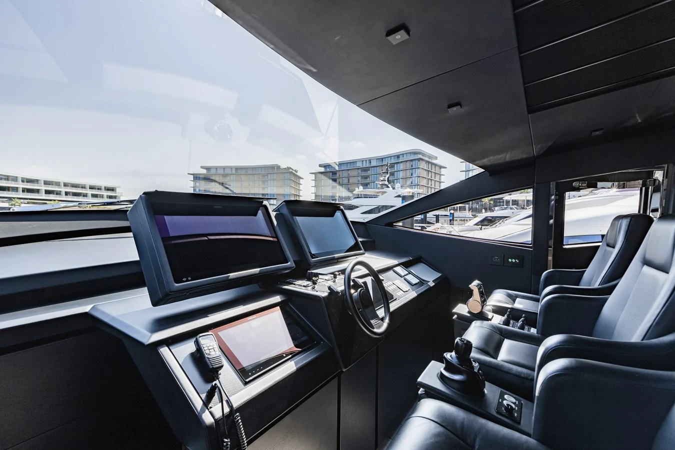 The helm station features advanced navigation equipment and luxurious seating. aboard 2021 PERSHING 8X Yacht for Sale