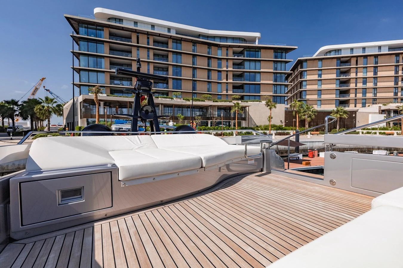 The yacht's aft deck features a spacious lounging area with plush seating and a beautiful view of the marina. aboard 2021 PERSHING 8X Yacht for Sale