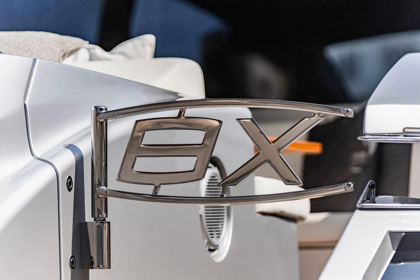 A close-up view of a sleek, metallic yacht emblem with modern design elements. aboard 2021 PERSHING 8X Yacht for Sale