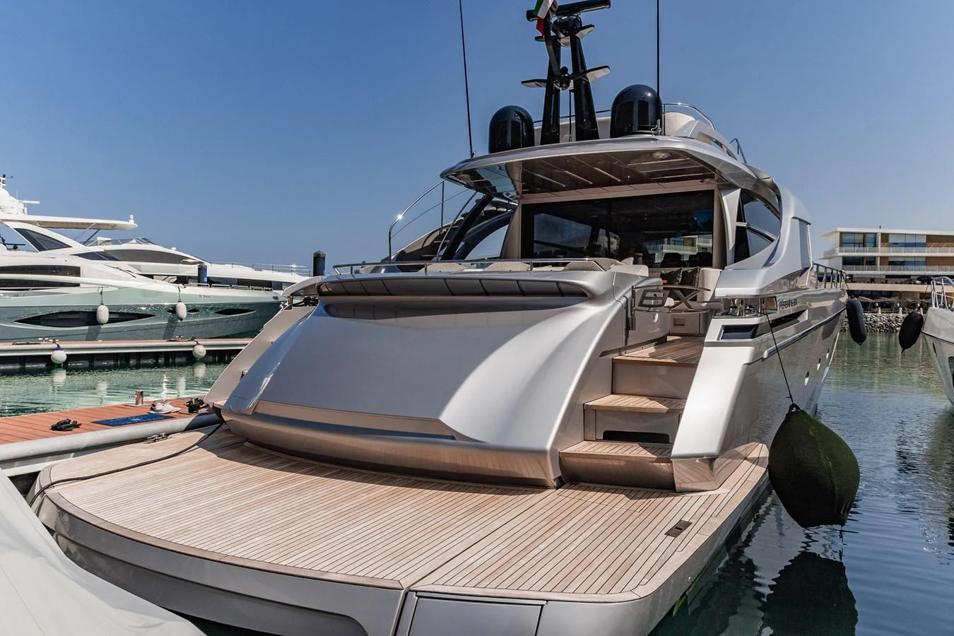 The yacht's sleek aft deck features a spacious swim platform and elegant steps leading to the main deck. aboard 2021 PERSHING 8X Yacht for Sale