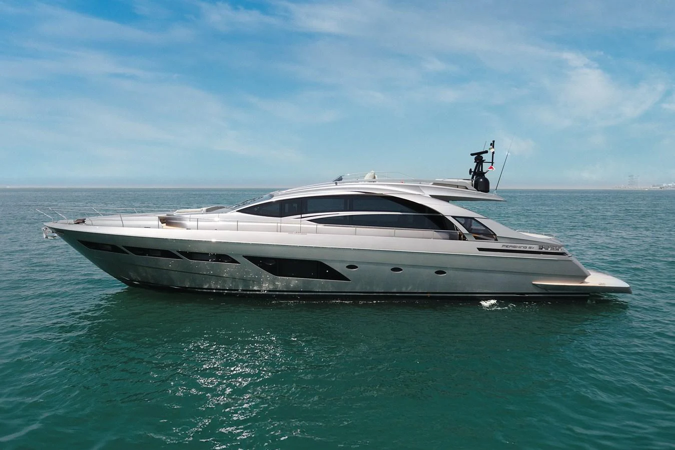 A sleek and modern yacht glides gracefully on calm waters under a clear blue sky. aboard 2021 PERSHING 8X Yacht for Sale