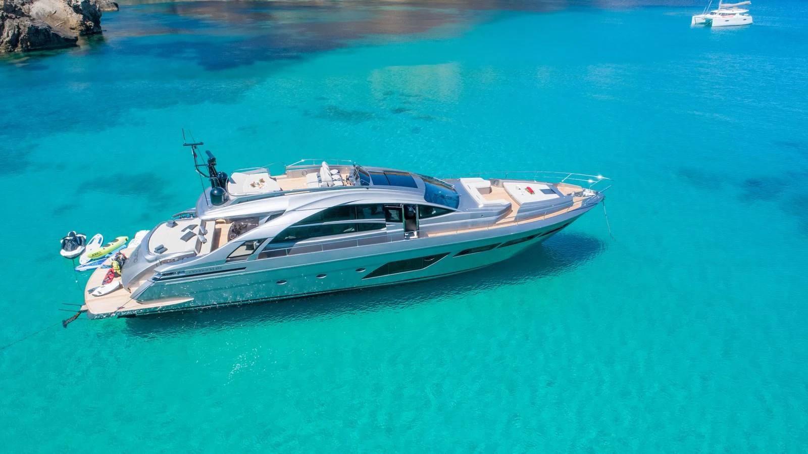 A sleek and modern yacht glides gracefully over crystal-clear turquoise waters. aboard DESERT STAR Yacht for Sale