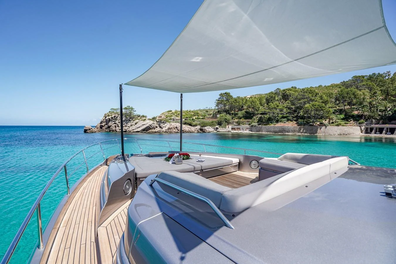 The foredeck offers a luxurious lounging area with a sunshade, perfect for relaxation while anchored in a serene bay. aboard DESERT STAR Yacht for Sale